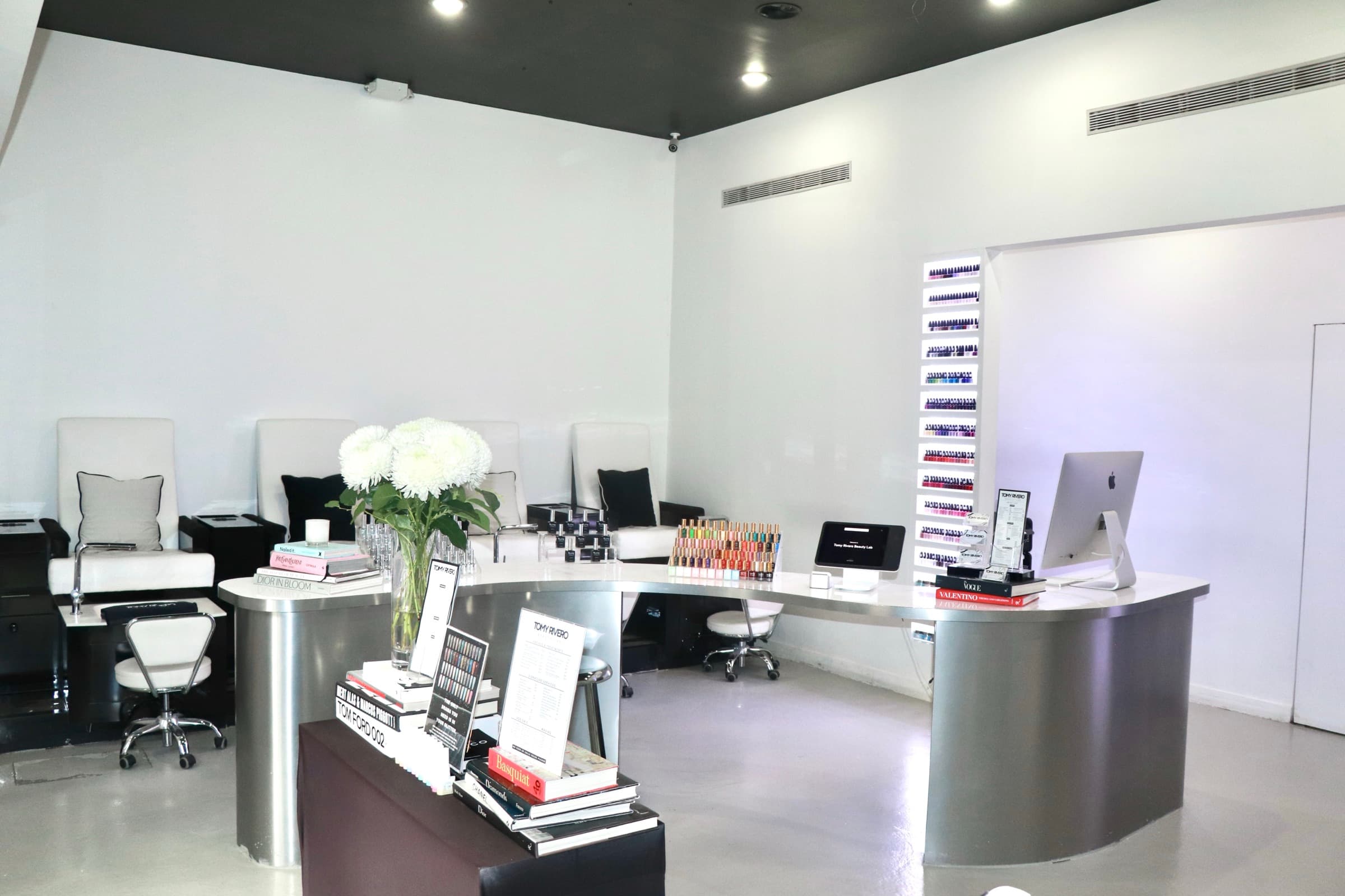 Reception counter, polish display, and seating inside Tomy Rivero Beauty Lab