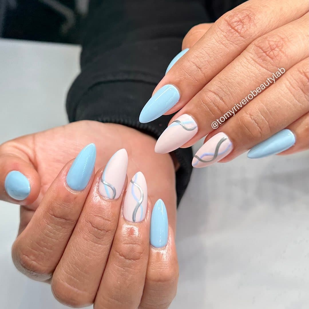 Sky blue and nude gel manicure with a hand-drawn silver swirl accent nail