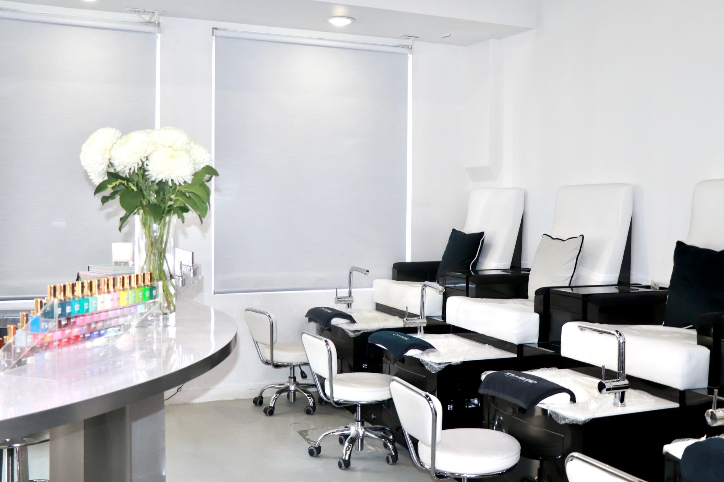 Beauty Lab pedicure stations with fresh white flowers on the counter