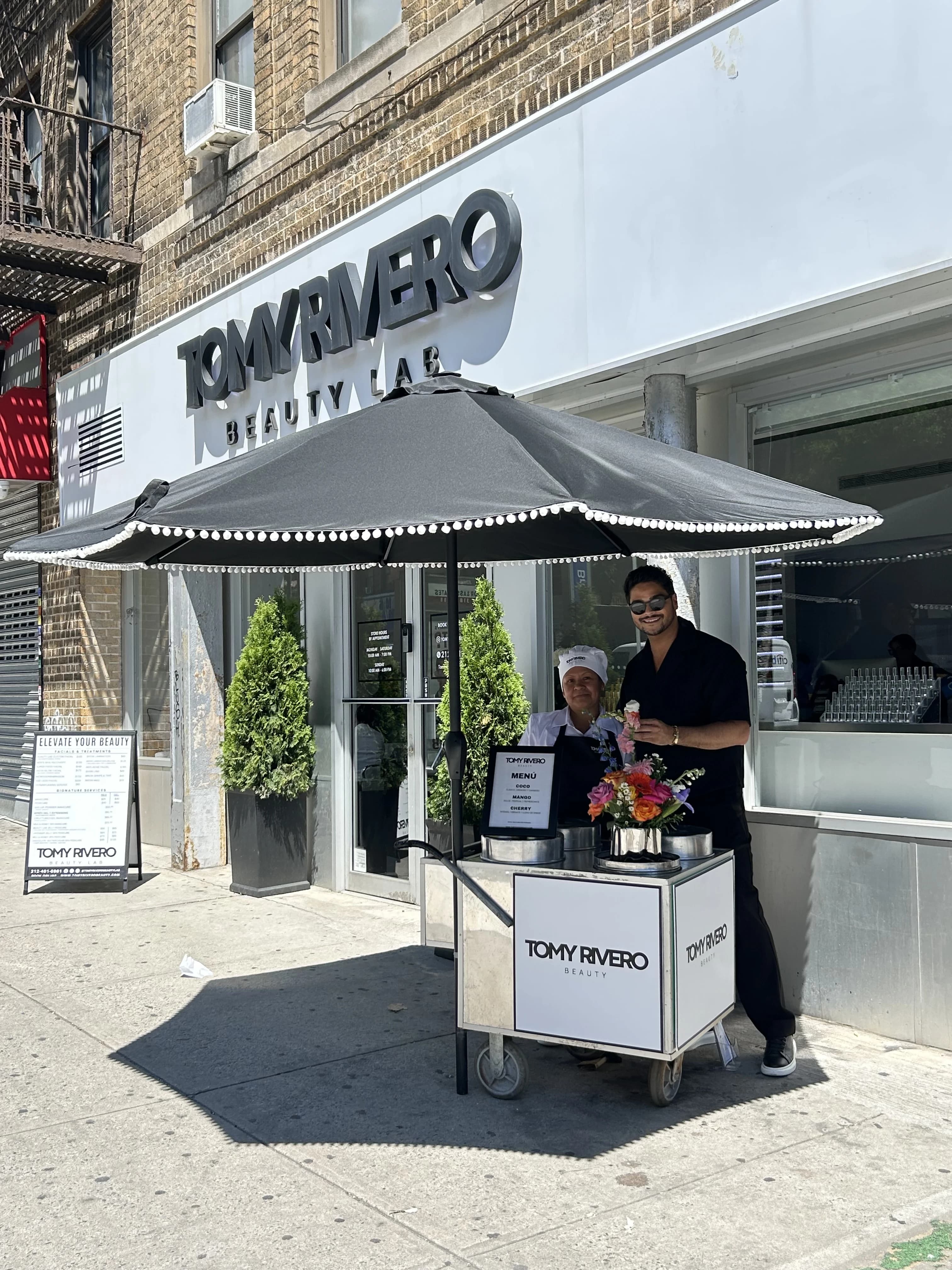 Tomy Rivero, a Beauty Lab team member, and a visitor together outside the studio